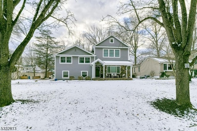 view of snow covered rear of property