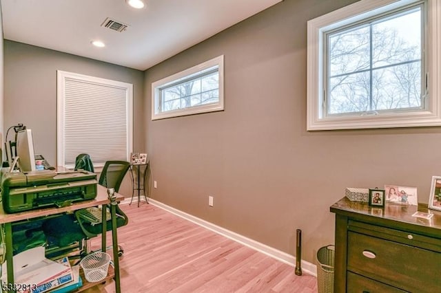 office space with light wood-type flooring