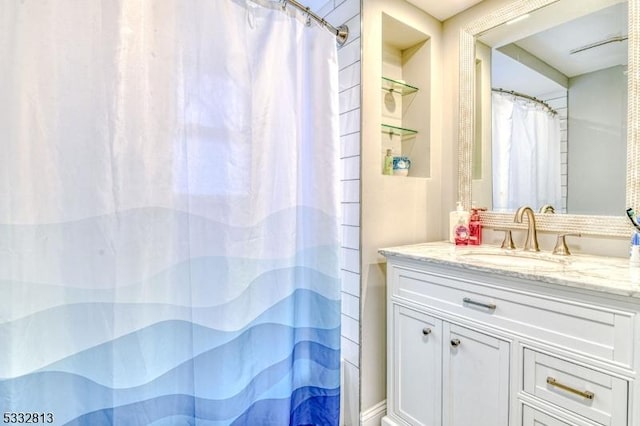 bathroom with walk in shower and vanity