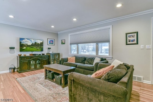 living room featuring light hardwood / wood-style floors and crown molding