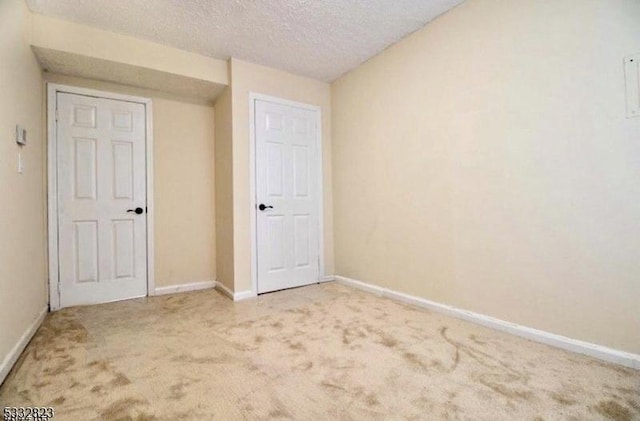 unfurnished bedroom with carpet flooring and a textured ceiling