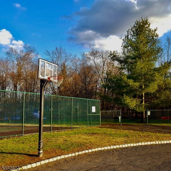 view of basketball court with a yard