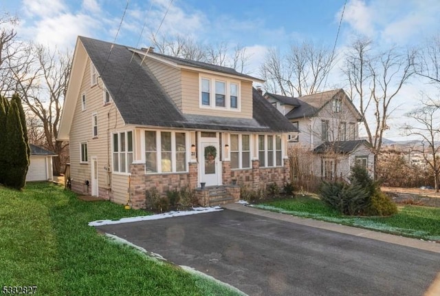 view of front of house with a garage and a front yard