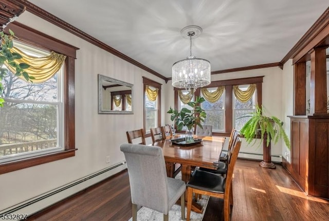 dining space with dark hardwood / wood-style floors, a wealth of natural light, an inviting chandelier, and a baseboard radiator