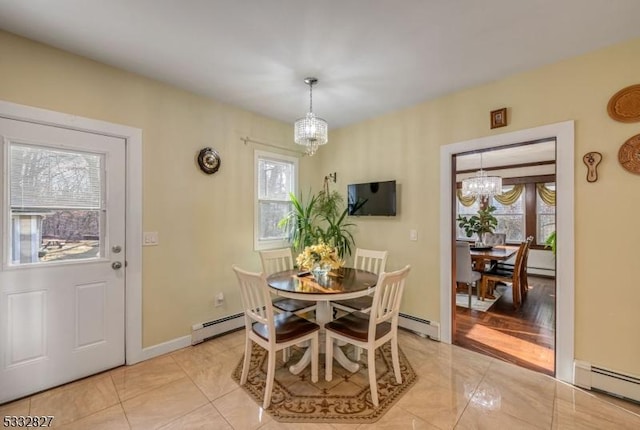 tiled dining space featuring a baseboard radiator, a wealth of natural light, and an inviting chandelier