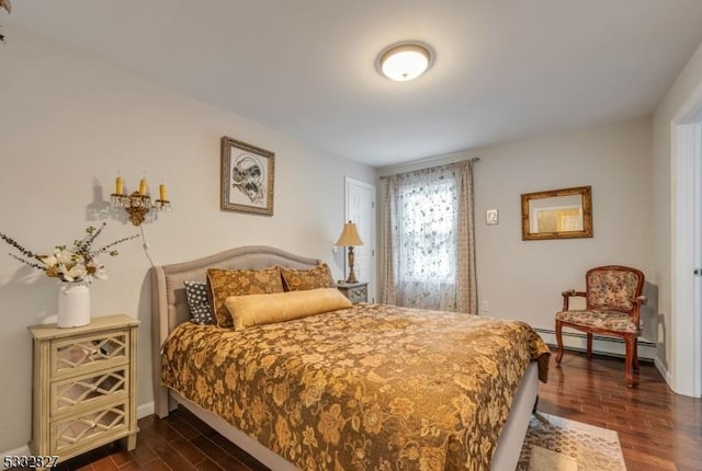 bedroom featuring a baseboard heating unit and dark hardwood / wood-style flooring