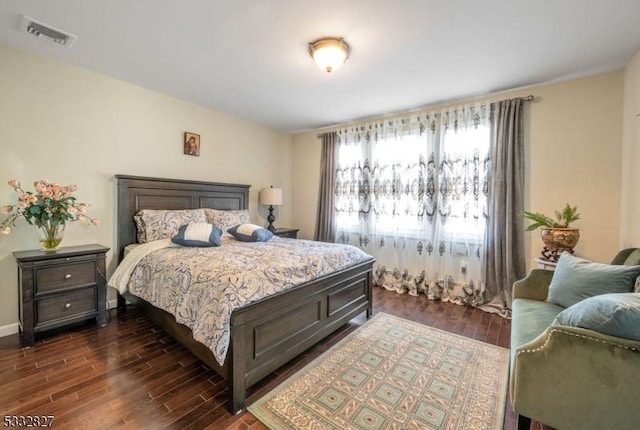 bedroom with dark hardwood / wood-style floors