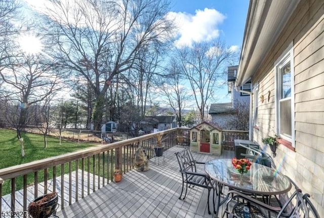 wooden deck featuring a yard