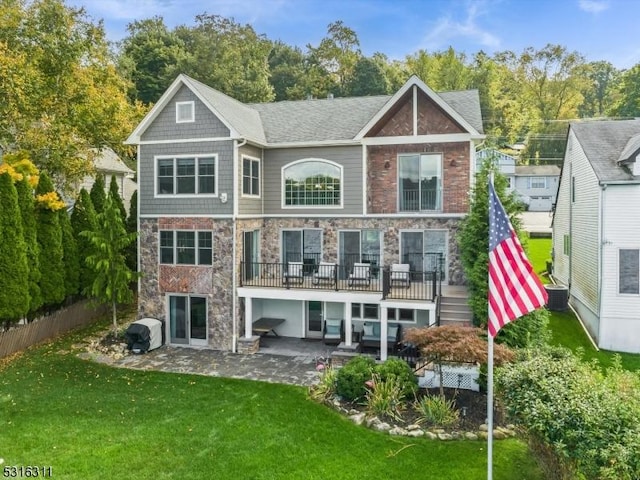 back of house featuring a lawn, central air condition unit, and a patio area