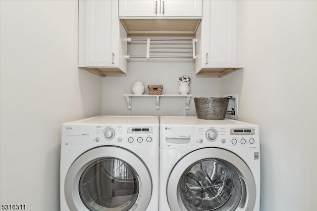 laundry area featuring independent washer and dryer and cabinets