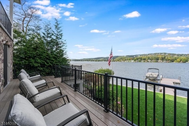 wooden deck featuring a boat dock, a yard, and a water view