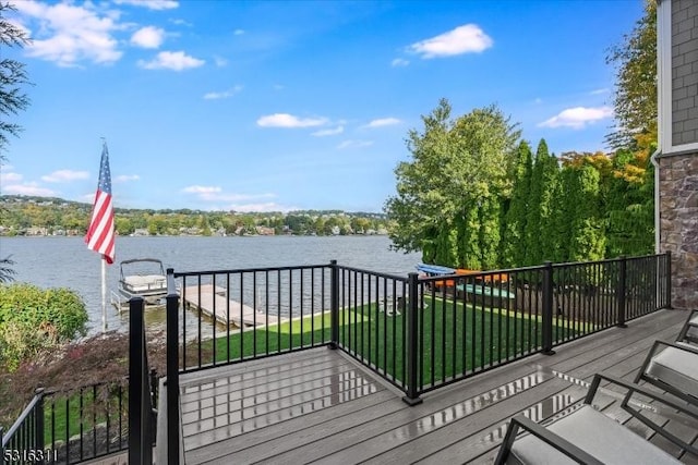 wooden deck featuring a yard and a water view