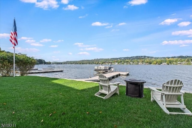 dock area featuring a water view and a lawn