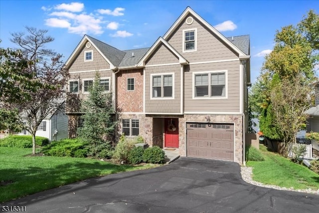 view of front of property featuring a front yard and a garage