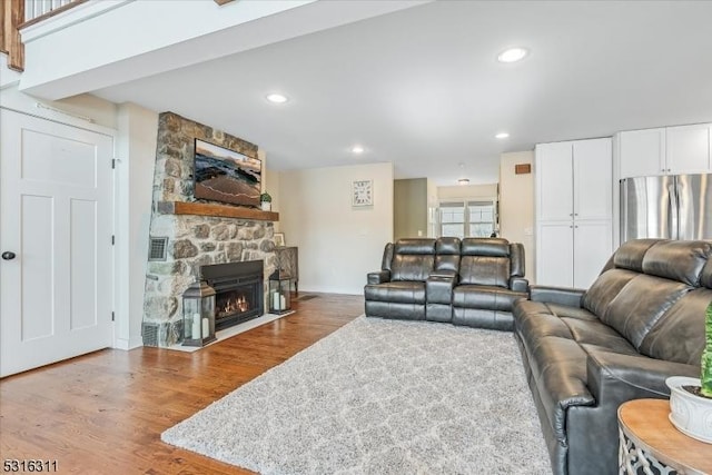 living room featuring a fireplace and wood-type flooring