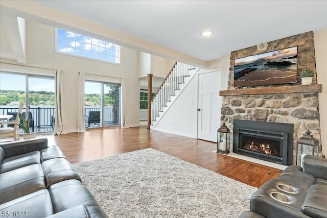 living room featuring hardwood / wood-style flooring and a stone fireplace