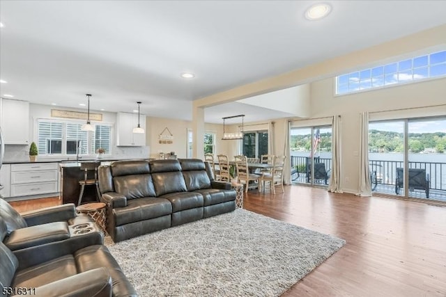 living room featuring sink and light hardwood / wood-style floors