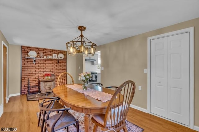 dining room featuring light wood-type flooring and a notable chandelier