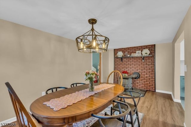 dining space with a notable chandelier and light hardwood / wood-style flooring