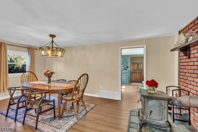 dining space with an inviting chandelier and hardwood / wood-style flooring