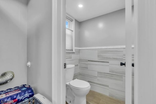 bathroom with hardwood / wood-style flooring and toilet