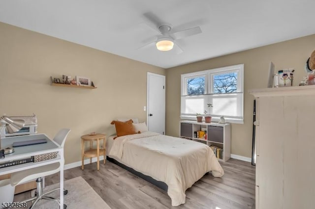 bedroom with ceiling fan and light hardwood / wood-style floors