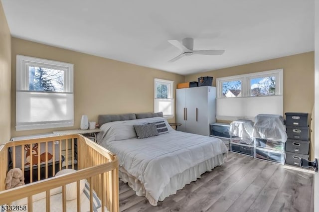 bedroom with ceiling fan and hardwood / wood-style floors