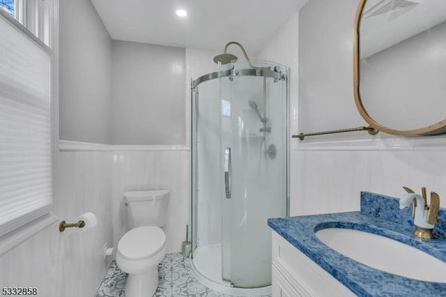 bathroom with toilet, tile patterned flooring, a shower with shower door, and vanity