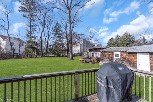 deck with grilling area and a lawn