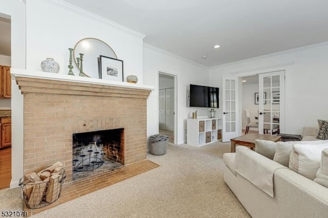 carpeted living room featuring ornamental molding, french doors, and a fireplace