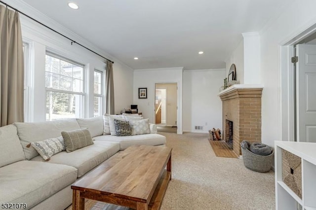 carpeted living room featuring a brick fireplace and ornamental molding