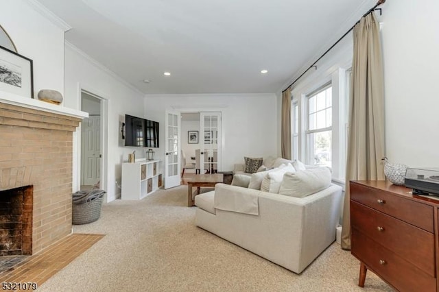 living room with ornamental molding, light colored carpet, and a brick fireplace