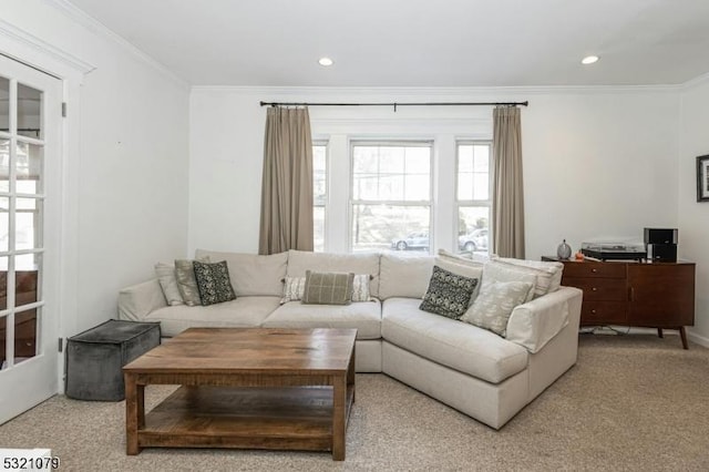 carpeted living room featuring ornamental molding