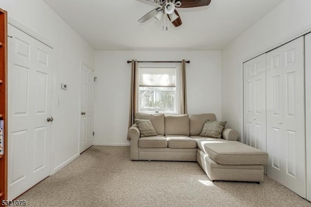 living room with light carpet and ceiling fan