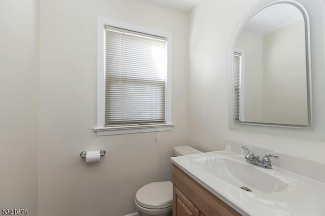 bathroom featuring toilet and vanity