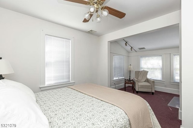 bedroom featuring ceiling fan, vaulted ceiling, and dark colored carpet