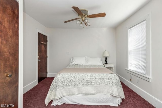 bedroom with dark colored carpet and ceiling fan