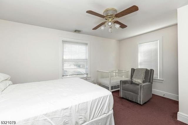 bedroom featuring ceiling fan and dark carpet