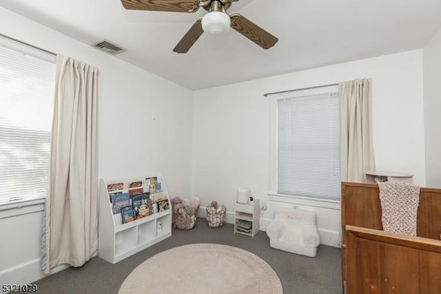 game room with dark carpet and ceiling fan