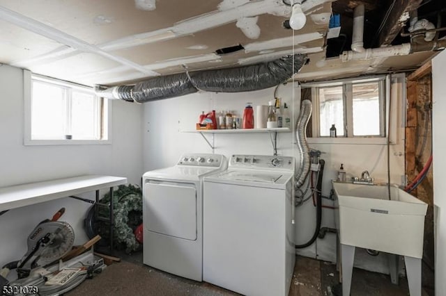 laundry room with sink, a wealth of natural light, and washing machine and clothes dryer