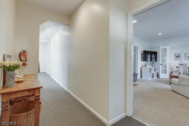 hallway with carpet floors