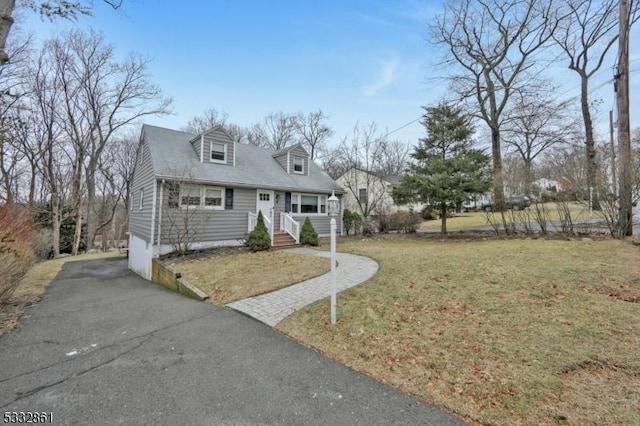 cape cod home with a front yard