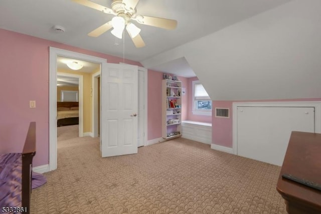 bonus room featuring ceiling fan, light carpet, and lofted ceiling