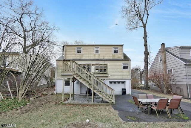 rear view of property with a garage