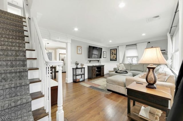 living room featuring ornamental molding and wood-type flooring