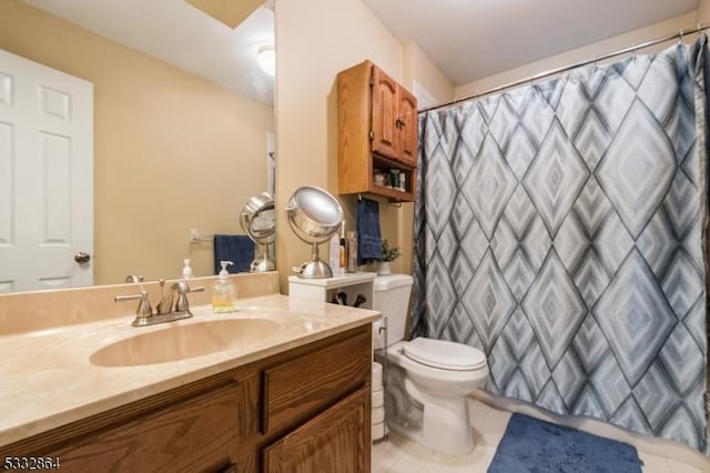 bathroom featuring tile patterned floors, toilet, vanity, and walk in shower