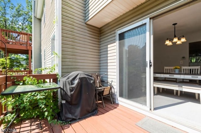 wooden terrace featuring a grill