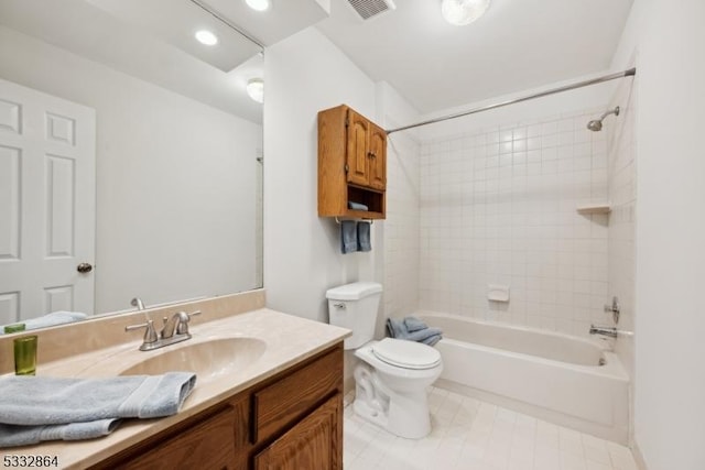 full bathroom with toilet, tiled shower / bath, and vanity