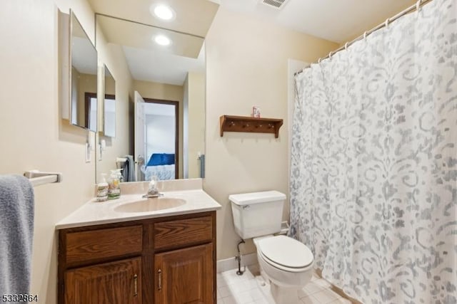 bathroom featuring toilet, vanity, and tile patterned floors