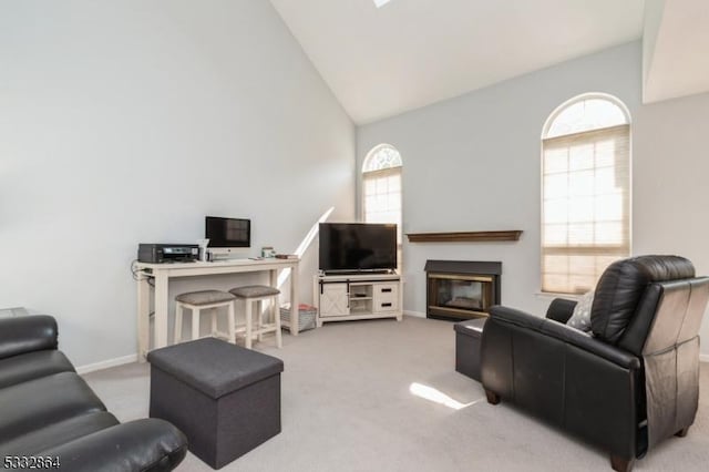 carpeted living room with high vaulted ceiling